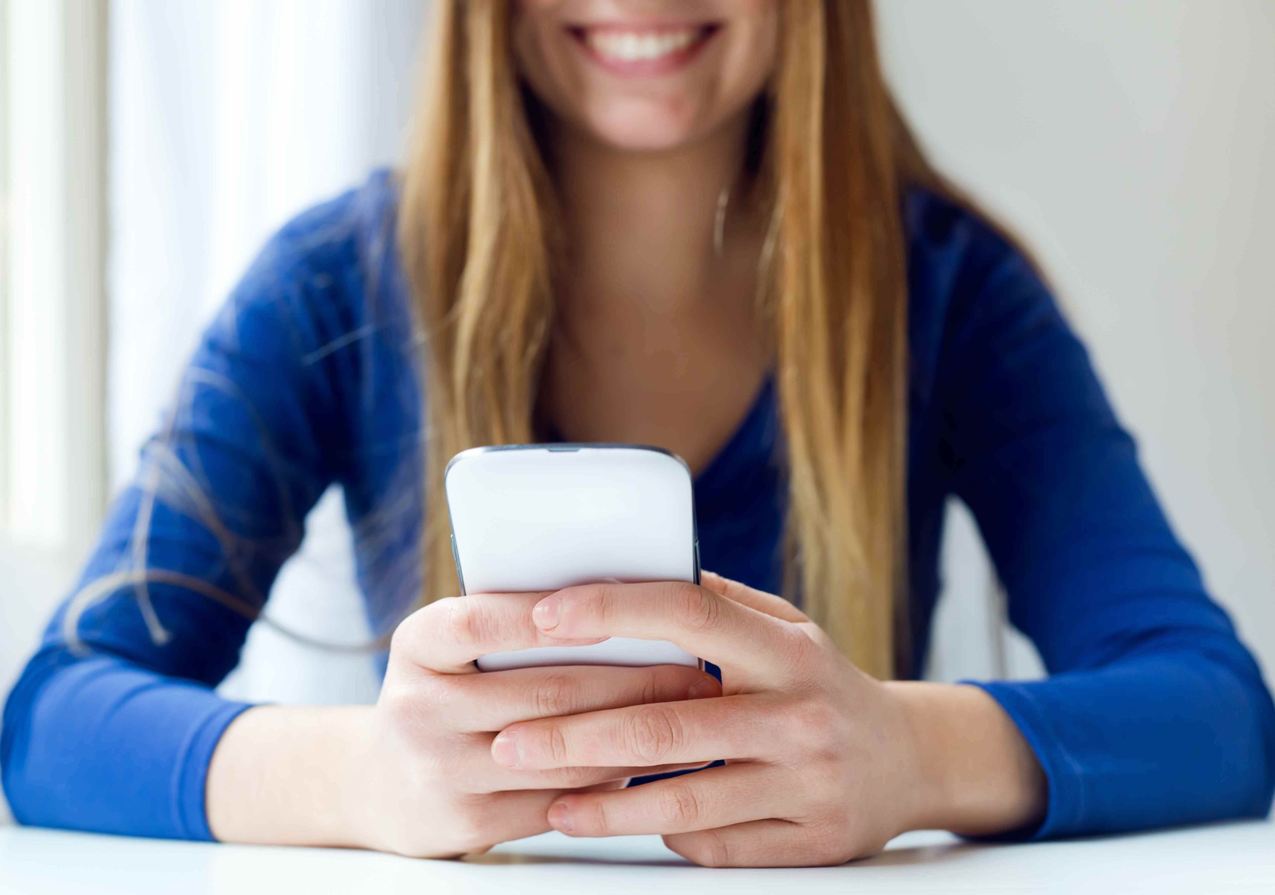 young-beautiful-woman-using-her-mobile-phone-home-11zon